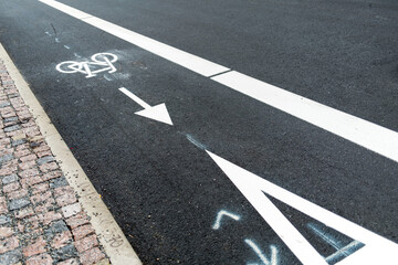 Freshly build bicycle lane in the city,Bike path. Sign white paint on the pavement. Summer. bicycle traffic sign painted on the asphalt.
