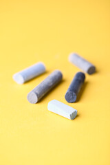 Soft pastels on yellow background. Close up. Copy space.