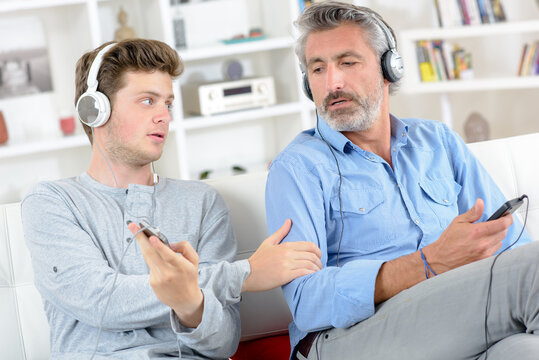 two men listening to the music