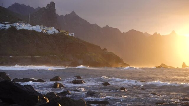 Ocean waves crash on rocks in sunset light Playa Benijo beach, Tenerife, Canary