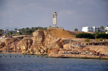 Lighthouse. Resorts and hotels at coast of Sharm El Sheikh from yacht. Egypt 