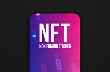 NFT nonfungible tokens concept background, logo on the screen of modern moble phone, top view photo