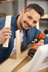 happy man and assemble of furniture