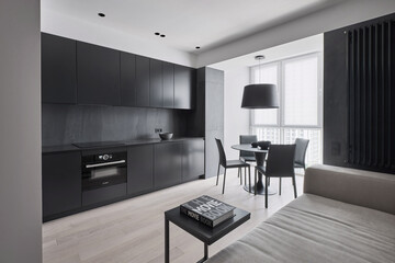 Black kitchen in a monochrome studio