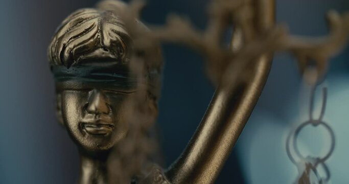 Justice blindfolded lady holding scales and sword statue