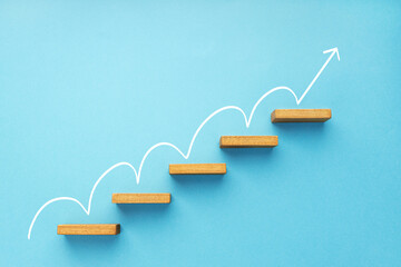 Rising arrow on staircase on blue background. Growth, increasing business, success process concept - obrazy, fototapety, plakaty