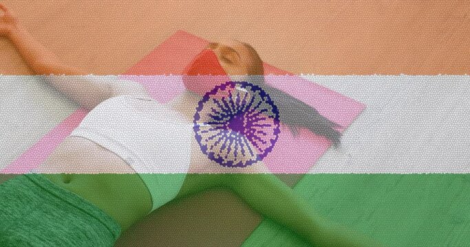 Animation of woman wearing face mask practicing yoga over indian flag