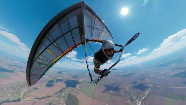 Bright rainbow colored hang glider soars on high altitude