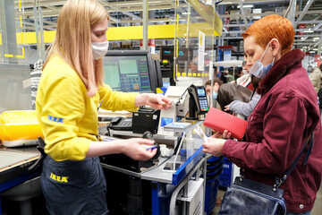 A young woman pays for purchases at the checkout of an IKEA hypermarket. Saint-Petersburg. Russia....