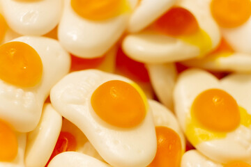 Sweet jelly like a scrambled eggs and candies with sugar. Macro.