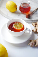 lemon tea with honey and ginger on table 
