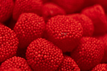 Red sweet jelly like berries and candies with sugar. Macro.