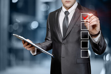 Businessman puts a check mark about the completed work on the virtual screen.
