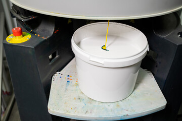 Plastic bucket with white paint for household needs © pressmaster