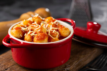 Gnocchi with tomato sauce and grated Parmesan cheese.