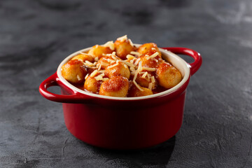 Gnocchi with tomato sauce and grated Parmesan cheese.