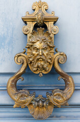 European Vintage old metal wrought iron door knocker. Design detail. Paris.