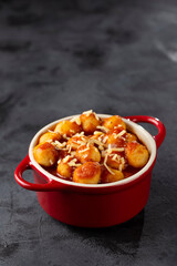 Gnocchi with tomato sauce and grated Parmesan cheese.