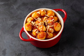 Gnocchi with tomato sauce and grated Parmesan cheese.