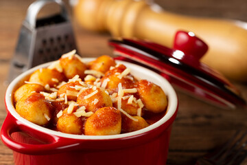 Gnocchi with tomato sauce and grated Parmesan cheese.
