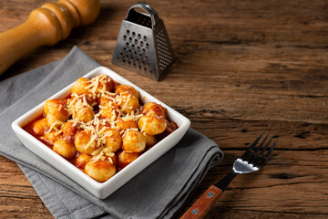 Gnocchi with tomato sauce and grated Parmesan cheese.