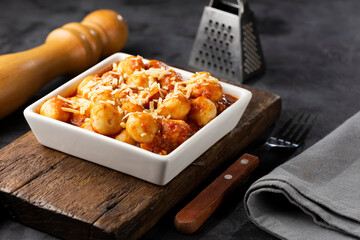Gnocchi with tomato sauce and grated Parmesan cheese.