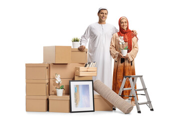 Young muslim couple packing for removal with a pile of cardboard boxes