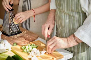 Close-up Photo of Cropped People Hands Holding Knife Cutting Food Meal For Cooking Using Cutting Board, Preparing Dinner, Family Time At Home, Cooking and Food Concept