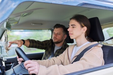 Father teaching his teenage son to drive