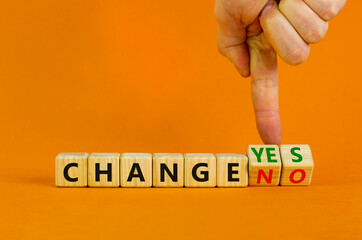 Change yes or no symbol. Businessman turns cubes and changes words 'change no' to 'change yes' or vice versa. Beautiful orange background. Copy space. Business, change yes or no concept.
