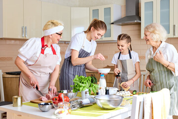 Fototapeta na wymiar Amicable family cooking in kitchen, sharing news and cooking tips, chopping ingredients for pizza,preparing dinner for family. side view