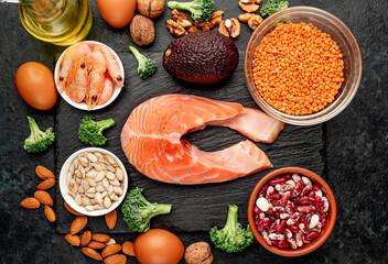 Different foods sources of omega-3 acids on a stone background