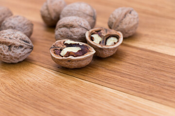 Obraz na płótnie Canvas Ripe walnuts on wooden rustic backdrop. Healthy nut food for brain. Fresh walnuts background concept