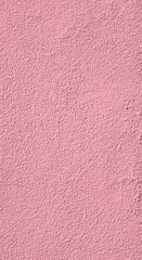 Texture of a plasterwork painted in pink used as an exterior coating on a building