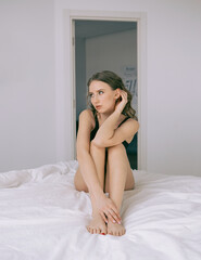 Beautiful and thin girl in the morning in the bedroom