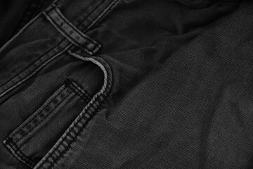 Pocket details of black jeans. Sewing details of black jeans.