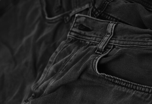 Pocket details of black jeans. Sewing details of black jeans.