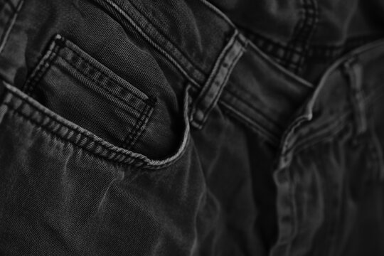 Pocket details of black jeans. Sewing details of black jeans.