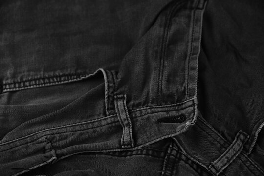 Pocket details of black jeans. Sewing details of black jeans.