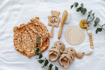 Newborn booties with empty card and wooden toys. Baby Background, top view, flat lay, copy space