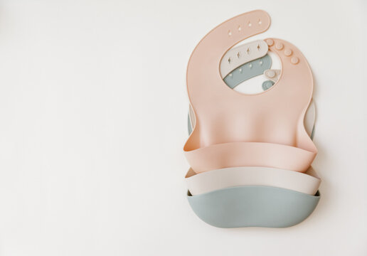 Silicone baby  bib with on neutral background. Top view, flat lay