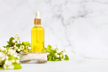 natural cosmetic product, serum, massage, aroma, essential oil in glass bottle with pipette on marble podium, background, text. anti cellulite, stretch marks, wrinkles, for face skin renewal and care.