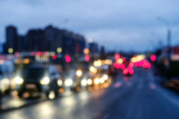 Background, blur, out of focus, bokeh. Traffic jams during rush hours after work. Red brake lights of stopped cars on the background of the city neighborhood.