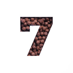 Number seven of nutritional chocolate cereal balls, white cut paper. Seventh numeral. Typeface for healthy dieting