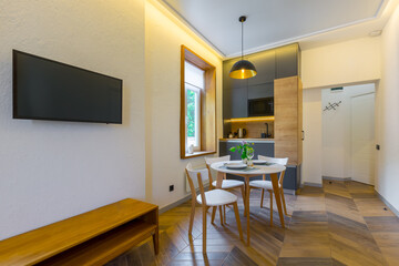 Interior photography, loft style, small apartment with warm light and dark kitchen