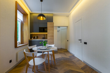 Interior photography, loft style, small apartment with warm light and dark kitchen