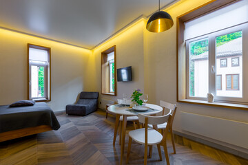 Interior photography, loft style, small apartment with warm light and dark kitchen