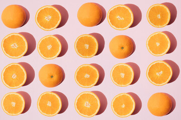 Arranged sliced ​​orange. Slices lined up on a blue background.
