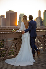 bride and groom in Brooklyn Bridge at sunset, New York