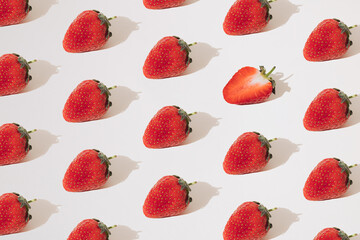 Arranged strawberries on a white background. Minimum pattern.